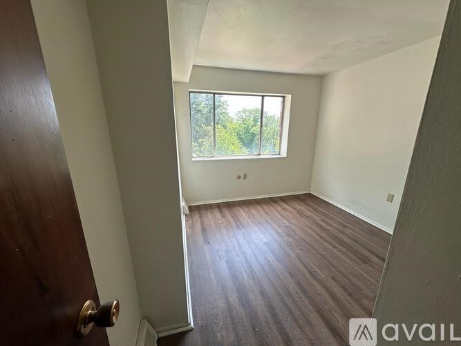 A room with a carpeted floor and a sliding glass door leading outside.