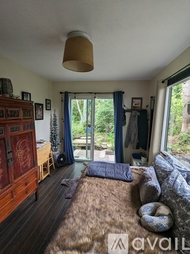 A living room with a brown furry sofa and a wooden cabinet.