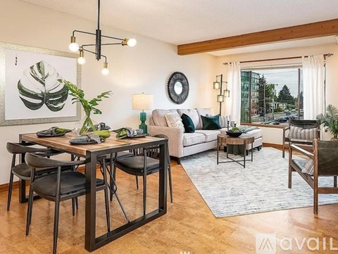 A living room with a dining table and chairs.