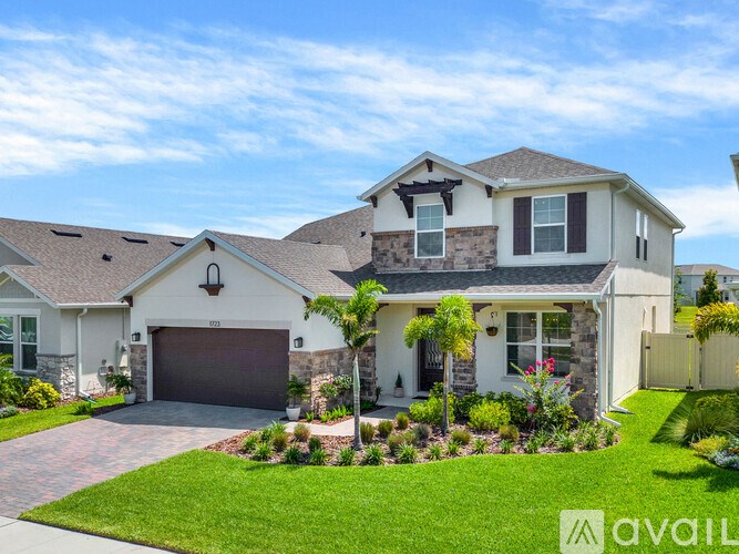 A house with a garage and a driveway is for sale.