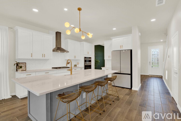 A modern kitchen with white cabinets and a large island.