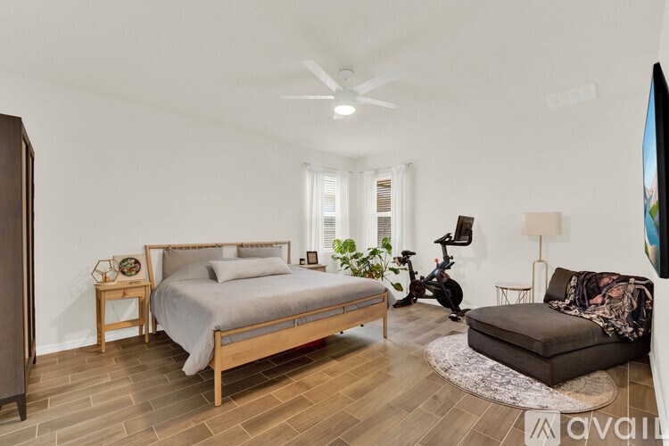 A bedroom with a large bed and a couch.