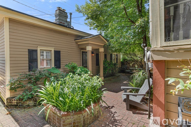 A house with a well-kept garden in front.