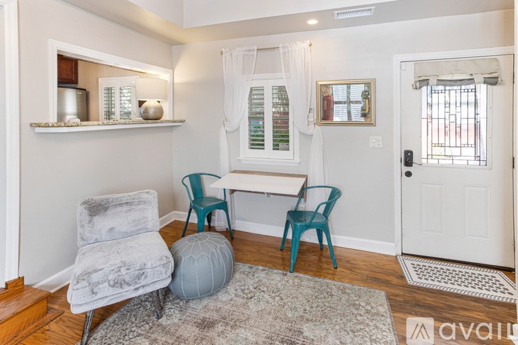 A living room with a grey chair and a white couch.