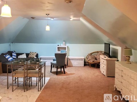 A living room with a dining table and chairs.