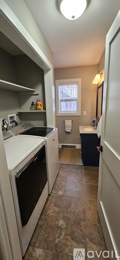 A kitchen with a black oven and a window.