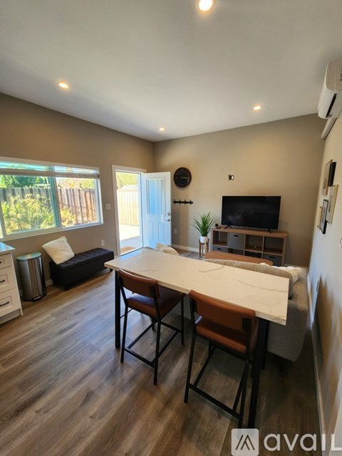 A living room with a brown table and chairs.
