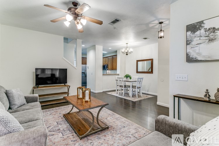 A living room with a grey couch and a wooden coffee table.