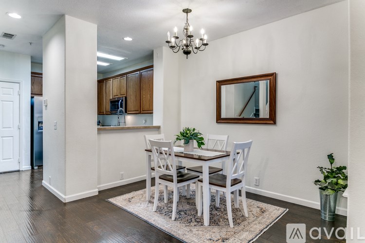 A dining room with a wooden table and chairs.