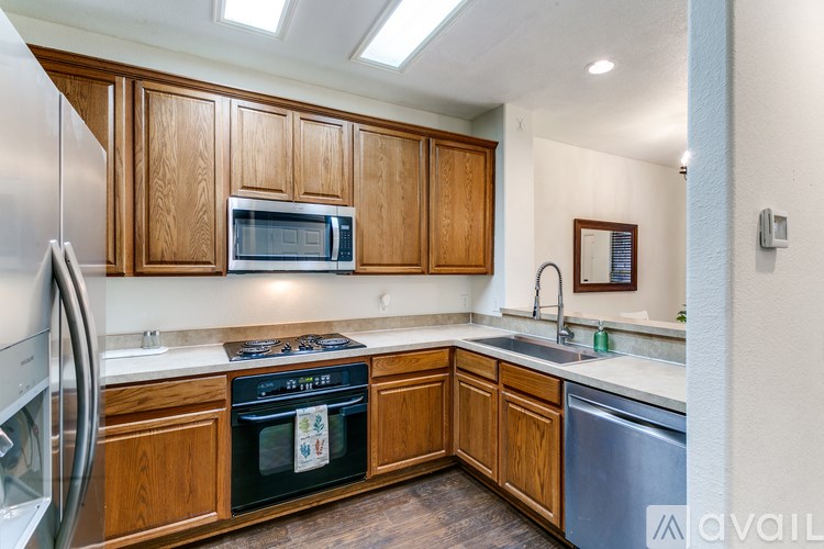 A kitchen with wooden cabinets and stainless steel appliances.