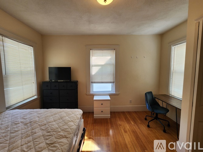 A hallway with a bench and a door.