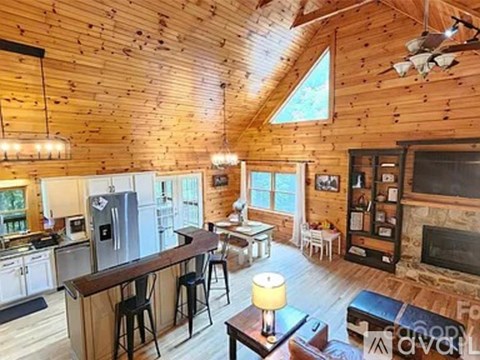 A cozy kitchen and living room in a log cabin.