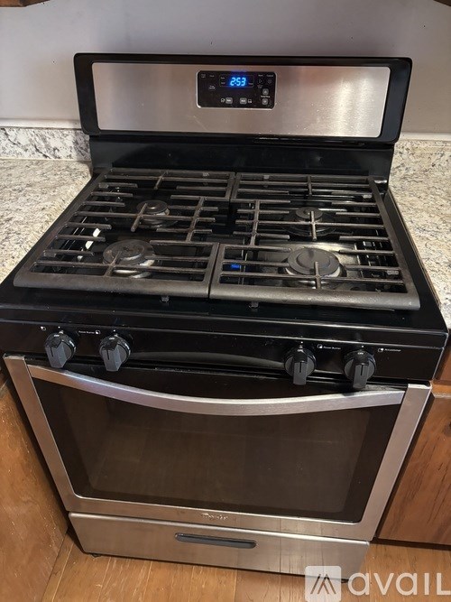 A modern stove top with a digital display showing 23 degrees.