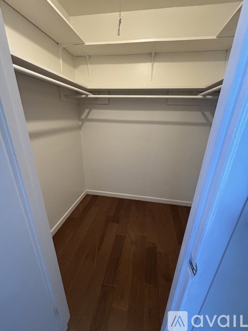 A room with white walls and wooden flooring.