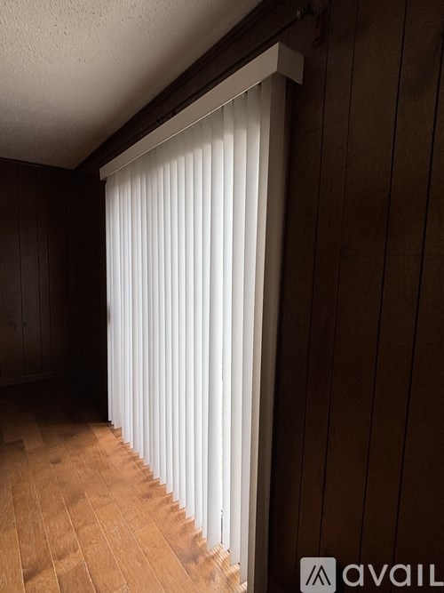 A ceiling fan with five blades is mounted on a white ceiling.