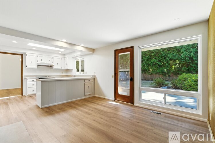A kitchen with white cabinets and a stainless steel oven.