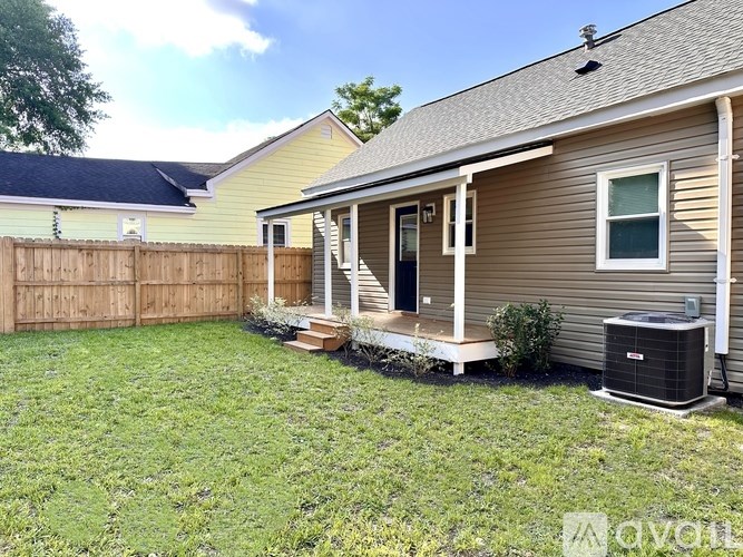 A house with a brown fence and a small porch.