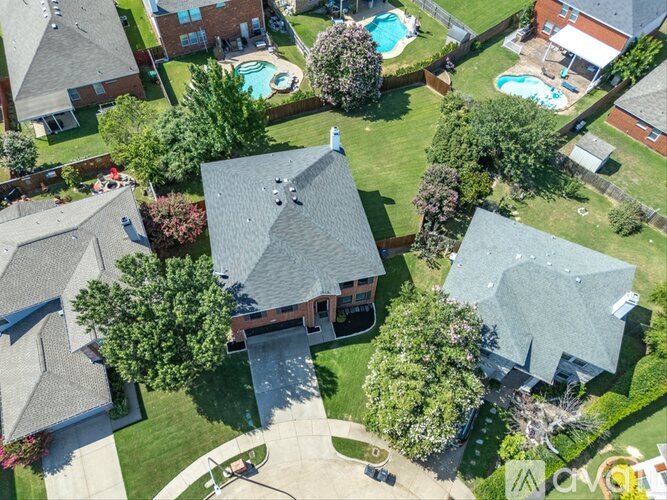 A bird's eye view of a neighborhood with houses and swimming pools.