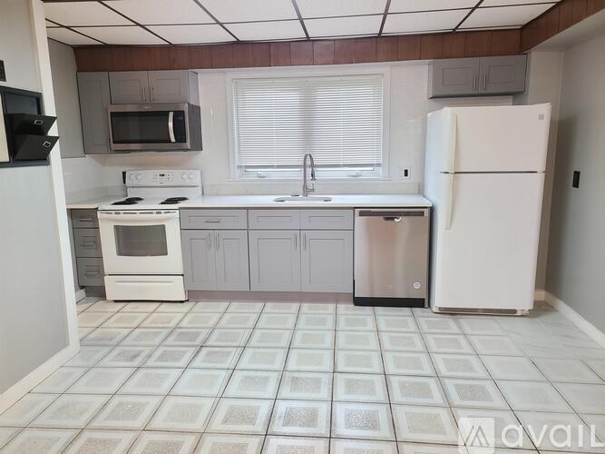 A kitchen with white appliances and a white refrigerator.