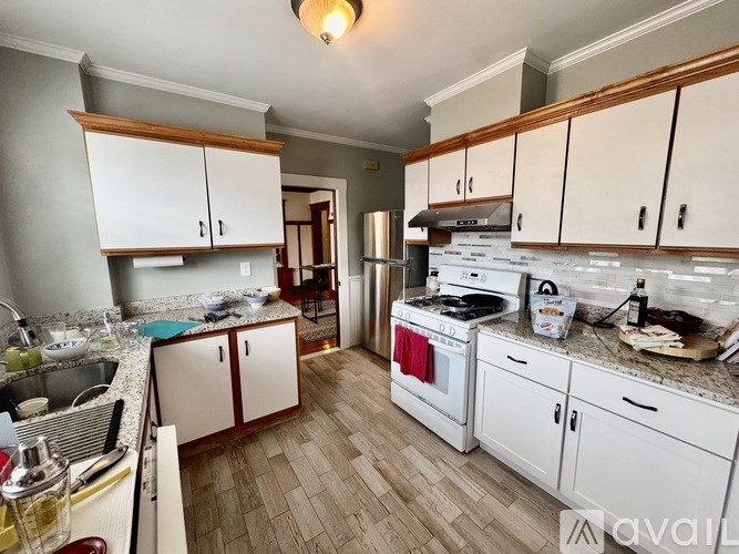 A kitchen with white cabinets and a wooden top.