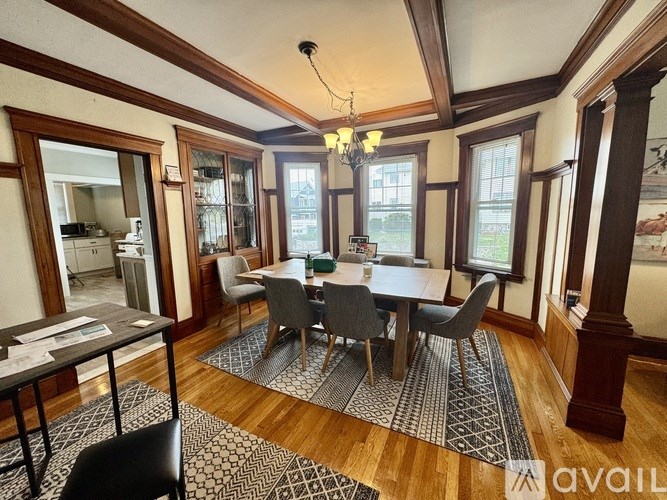 A dining room with a table set for six.