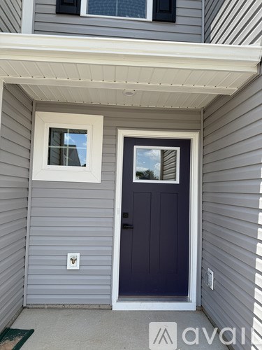 A house with a dark grey door and a white window.