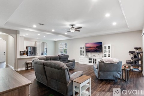 A living room with a grey couch and a wooden table.
