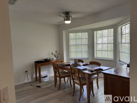 A dining room with a table set for six people.