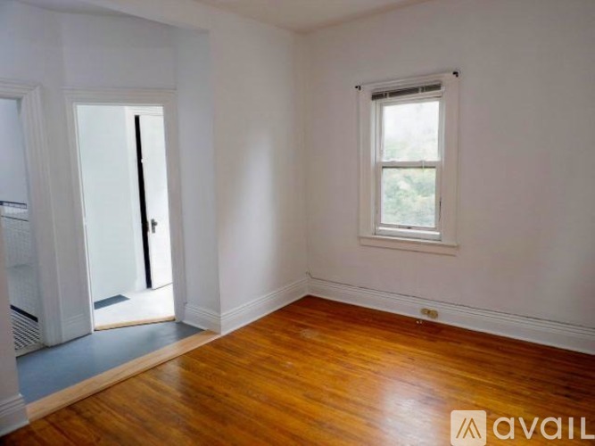 A room with wooden floors and a window.