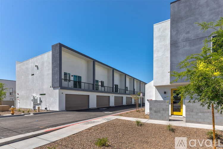 A modern building with a yellow door is available for rent.