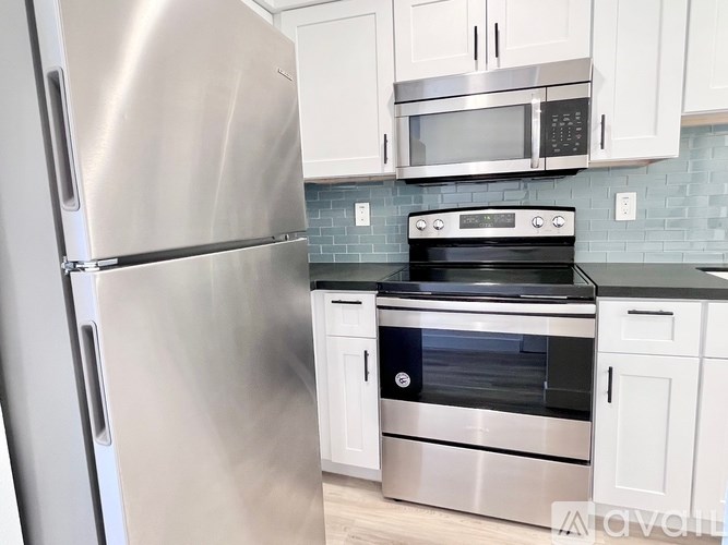 A kitchen with a stainless steel refrigerator and oven.