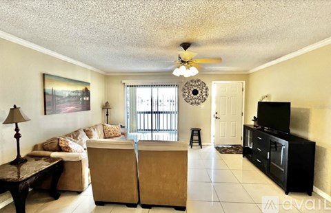 A living room with a sofa set, a television, and a painting on the wall.