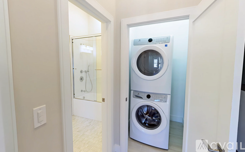 A white washing machine and dryer in a small laundry room.