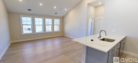 A kitchen area with a sink and a window.