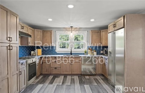 A kitchen with wooden cabinets and a window.