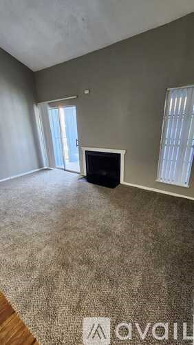 A living room with a television and carpeted floor.