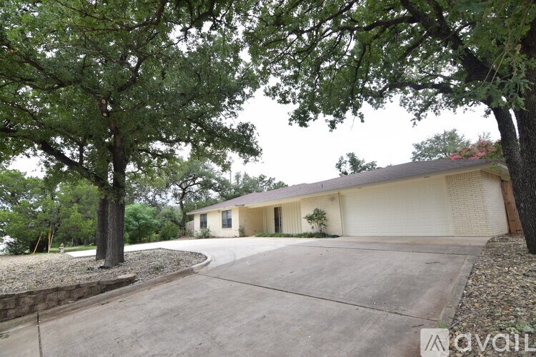 A house with a circular driveway in front of it.