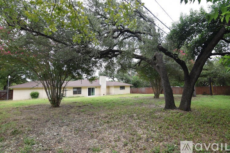 A house is surrounded by trees and grass.