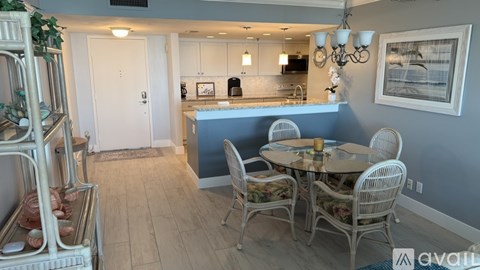 A dining room with a table set for four.