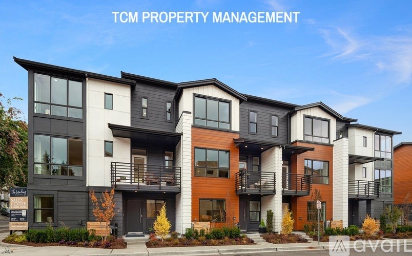 A modern multi-story building with the text "TCM PROPERTY MANAGEMENT" at the top.