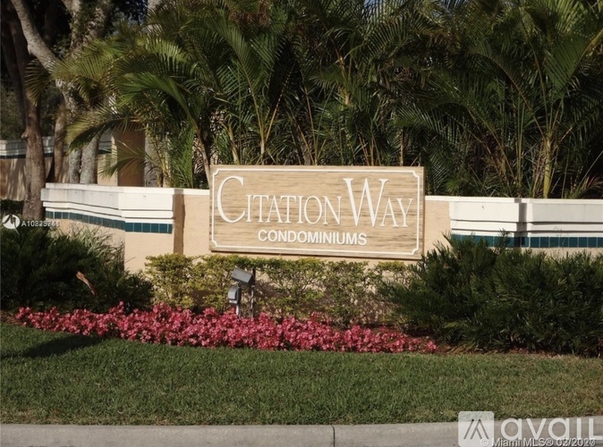 A sign that says "Citaton Way Condominiums" in front of some trees.