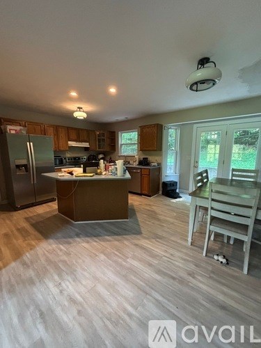 A kitchen with a refrigerator, stove, and sink.