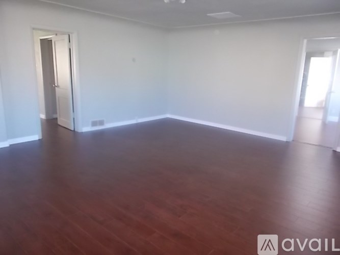 A room with wooden floors and white walls.