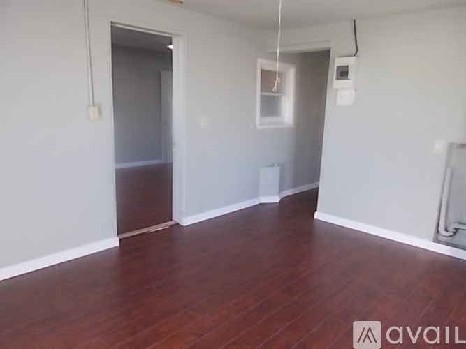 A room with wooden floors and white walls.