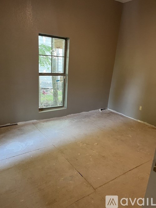 A room with a window and a wall with a logo that says "avail".