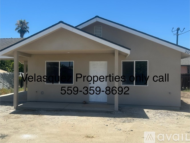 A house with the text "Melasque Properties only call 559-359-8692" on it.