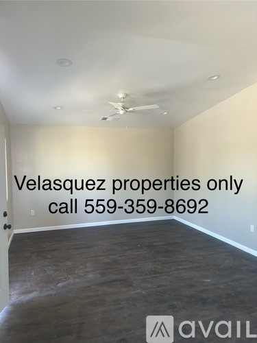 A room with a message about Velasquez properties and a phone number.