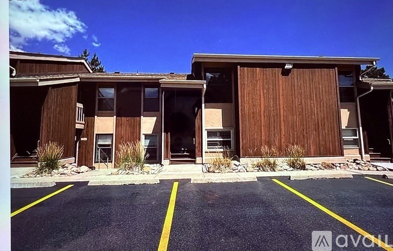 A parking lot in front of a building with the logo "avon" on it.