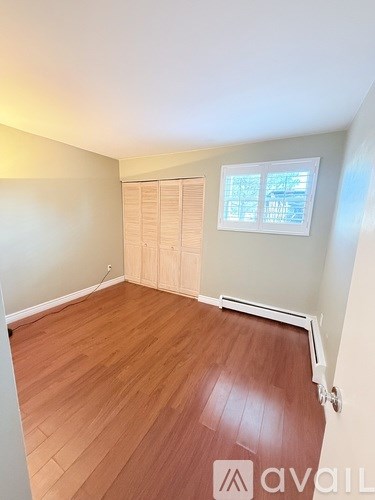 A kitchen with white cabinets and a black oven.