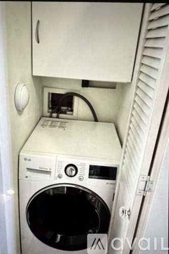 A white washing machine and dryer in a small laundry room.